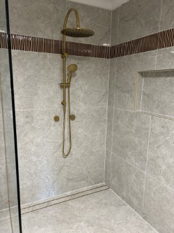 Completed shower with brushed brass fixtures